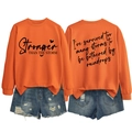 Detailed front and back view of orange Stronger Than The Storm crewneck sweatshirt - S / Black Font / Orange