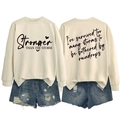 Front and back detail of a beige sweatshirt featuring Stronger Than The Storm text print - S / Black Font / Sand