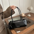 Chic black underarm bag with bow drawstring details and a glossy finish - Black