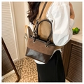 Detail of vintage brown bucket bag showing suede and smooth leather texture with metal eyelets - Brown