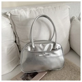 Close-up of metallic silver pillow bag with bow detail and textured faux leather finish - Silver