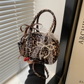Leopard print pillow bag with bow and cherry charms shown in soft lifestyle lighting - Leopard Coffee