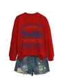 Detailed view of red crewneck sweatshirt with vintage print and distressed denim shorts - S / Red