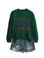 Close-up of a dark green sweatshirt with a vintage carriage print and distressed denim shorts - Dark Green