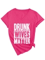 Macro detail of V-neck fuchsia T-shirt with white text and decorative bottom knot - Rose Red (White Font)