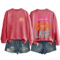 Detail of red Lake Days sweatshirt and distressed denim shorts in flat lay view - Red-White Text Print