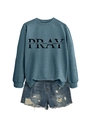 Flat lay of a misty blue Pray sweatshirt and distressed denim shorts with frayed edges - Blue (Black Font)