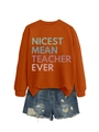 Flat lay of orange sweatshirt with Nicest Mean Teacher Ever print and denim shorts - Burnt Orange