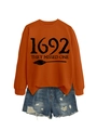 Detail of orange cotton sweatshirt with 1692 print and ripped denim shorts on white background - Burnt Orange (Black Font)