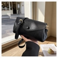 Detail of a minimalist black leather crossbody bag with a round flap clasp and gold buckle - Black
