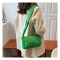 Detail of green quilted nylon crossbody bag with adjustable wide shoulder strap on model - Green