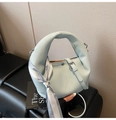 Macro detail of light blue lychee pattern leather bag with silk scarf and metal buckle - Blue