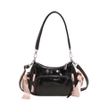Black patent leather shoulder bag featuring delicate pink ribbon bows and silver hardware - Black