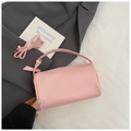 Pink lychee grain leather barrel bag with adjustable strap on a minimalist background - No Pendant / Pink