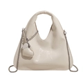 Detailed macro view of white pleated leather bag with silver heart charm and chain strap - White