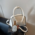 White leather bowling handbag with black trim and contrast charm in a stylish variant - Off White