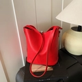 Bright red pebble leather bucket bag featuring a unique silver metallic sphere buckle - Red