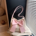 Straw shoulder bucket bag in beige featuring a large pink bow decoration and slim straps - Pink
