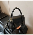 Close-up of the black leather and textured weaving contrast on a chic crossbody bag - Black