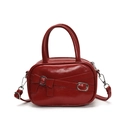 Glossy red bowler handbag with silver buckle and crossbody strap detail - Red