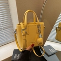 Mini yellow lychee pattern bucket bag with adjustable shoulder strap and top handle - Yellow