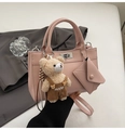 Pink leather handbag detail featuring a cute bear pendant and a matching mini envelope pouch - Pink With Pendant