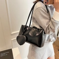 Minimalist black patent leather tote bag for women with a heart-shaped charm accessory - Black