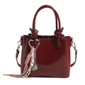 Fashionable wine red glossy leather bucket bag with silver heart charm and crossbody strap - Burgundy With Badminton Charm