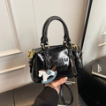 Glossy black patent leather Boston bag with MUHETI lettering and horse charm - Black with Pendant