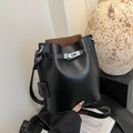 Minimalist black litchi grain bucket bag with silver metal swivel lock and strap detail - Black