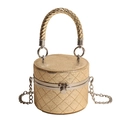Gold cylindrical quilted box bag with a metallic finish and woven handle detail - Gold