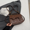 Brown vintage faux leather satchel with dual straps and buckle details in a scene - Standard / Brown