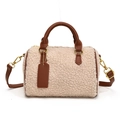 Detail van de pluche Boston tas van crème imitatiebont met donkerbruine leren bies en goud - Bruin