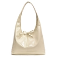 Macro view of cream patent leather underarm bag with decorative bow and glossy finish - White