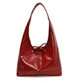 Detail of burgundy glossy leather underarm bag with a decorative bow knot and shoulder strap - Red