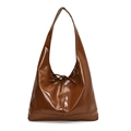 Detail of glossy brown faux leather underarm bag with a decorative ribbon bow - Brown