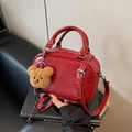 Red crackle-finish leather Boston bag with a teddy bear keychain and long strap - Burgundy