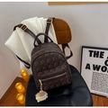 Dark brown leather mini backpack with gold bear prints and white plush pendant accessory - Brown
