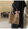 Brown litchi pattern tote bag with plaid silk scarf detail on female model - Brown