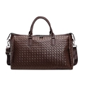 Detailed view of a dark brown woven faux leather travel bag featuring a durable shoulder strap - Coffee