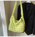 Detail of light yellow quilted puffy shoulder bag featuring a wide strap and zip closure - Green