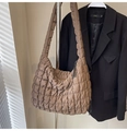 Detail of brown quilted puffer shoulder bag featuring square stitched texture and zipper - Brown
