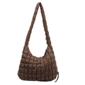 Detailed view of a brown quilted puffer shoulder bag featuring a soft textured bubble design. - Coffee