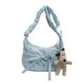 Light blue fabric crossbody bag with bow design and Gromit plush charm on white background - Blue
