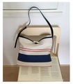 Close-up of canvas bucket bag with red and blue stripes and horn buckle closure - One Size / Off White