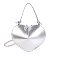 Macro detail of glossy silver heart-shaped handbag showing smooth metallic finish and zippers - Silver