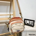 Versatile orange and beige crossbody bag with adjustable strap and bungee cord detail - Orange