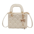 Elegant white quilted crossbody handbag with a gold bunny pattern and pearl tassel charm - Off White