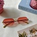 Detail of rimless gradient sunglasses featuring golden metal temples and leopard head decor - Pink