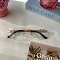 Gafas de sol sin montura doradas con lentes de borde ondulado y patillas de doble anillo - Transparente